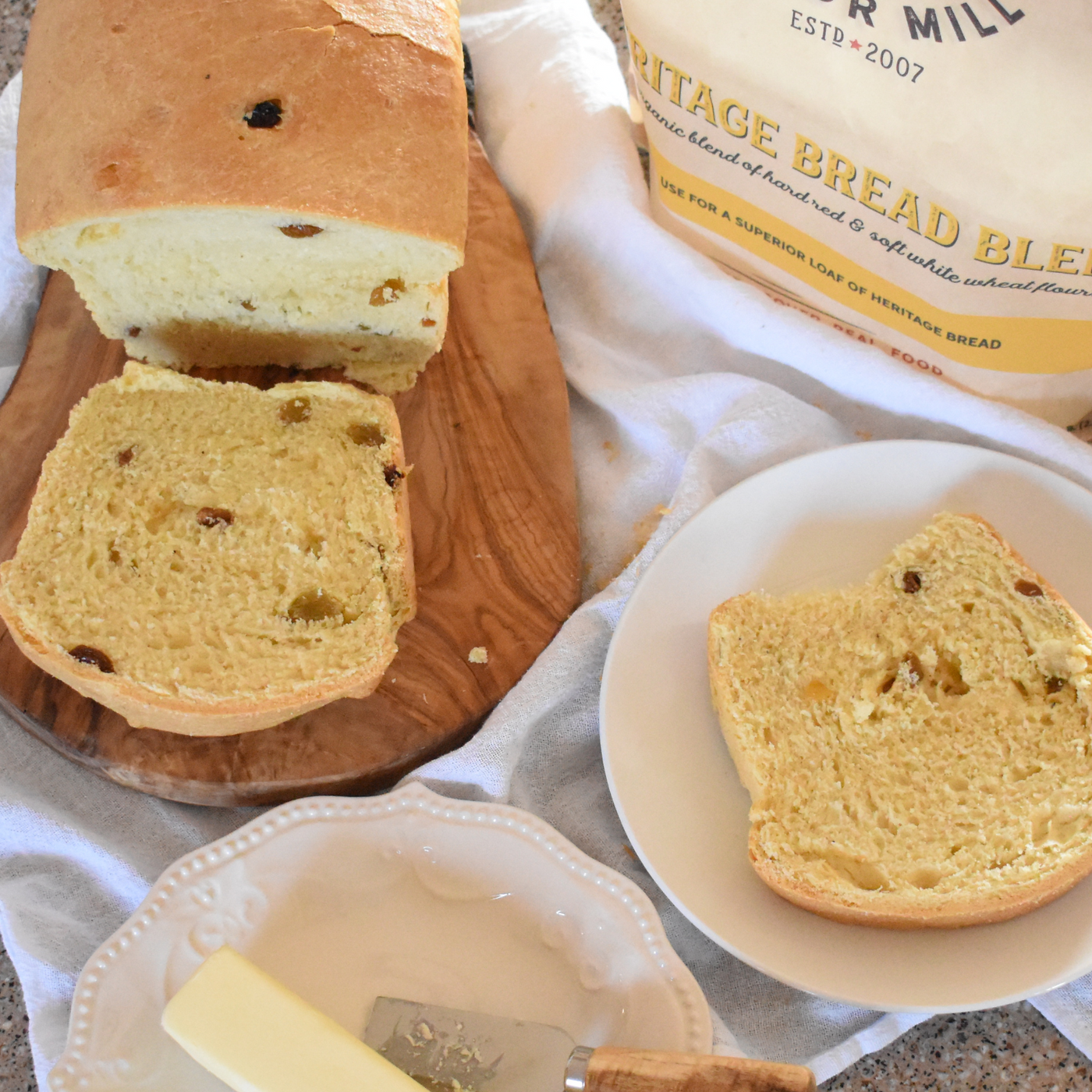 Raisin bread next to a bag or bread blend